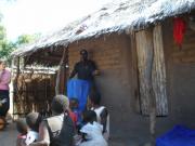 Alexander (ACT) explaining to a family the importance of the nets, how to use them, and how to maintain them.