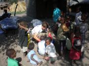 Gwilym (Zikomo) preparing mosquito nets with the children of Namakoma village in August 2008.