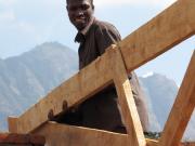 Foreman Edson Chingamwali getting the roof on before the rainy season